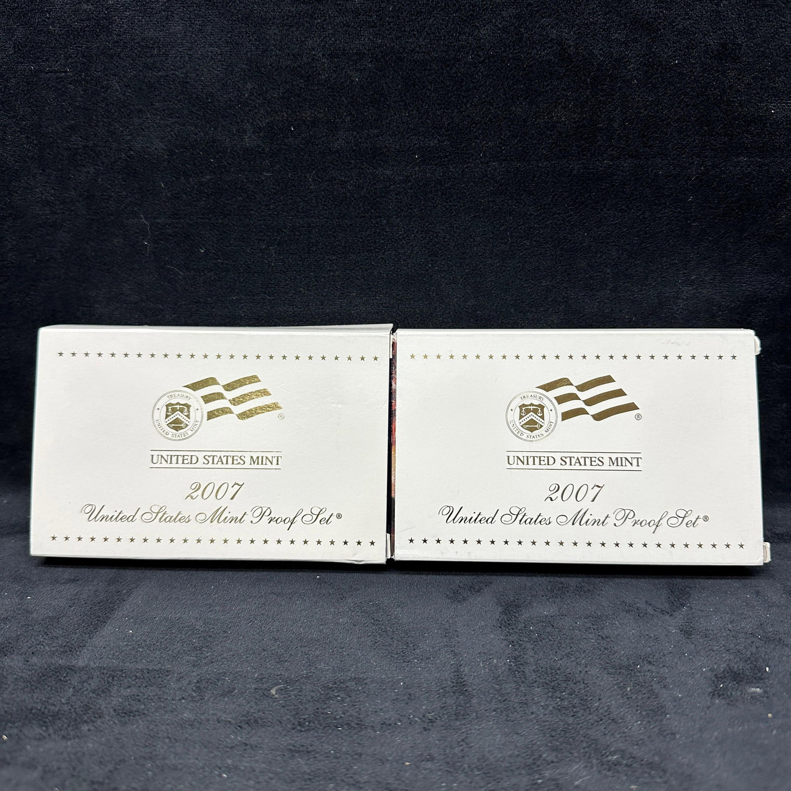 2007 United States Mint Proof Sets With State Quarters Presidential Dollars Lot of 2: A lot of two 2007 United States Mint proof sets in original government packaging with outer boxes and certificates of authenticity. Each set includes the standard clad proof coins, 50 State Quarters p