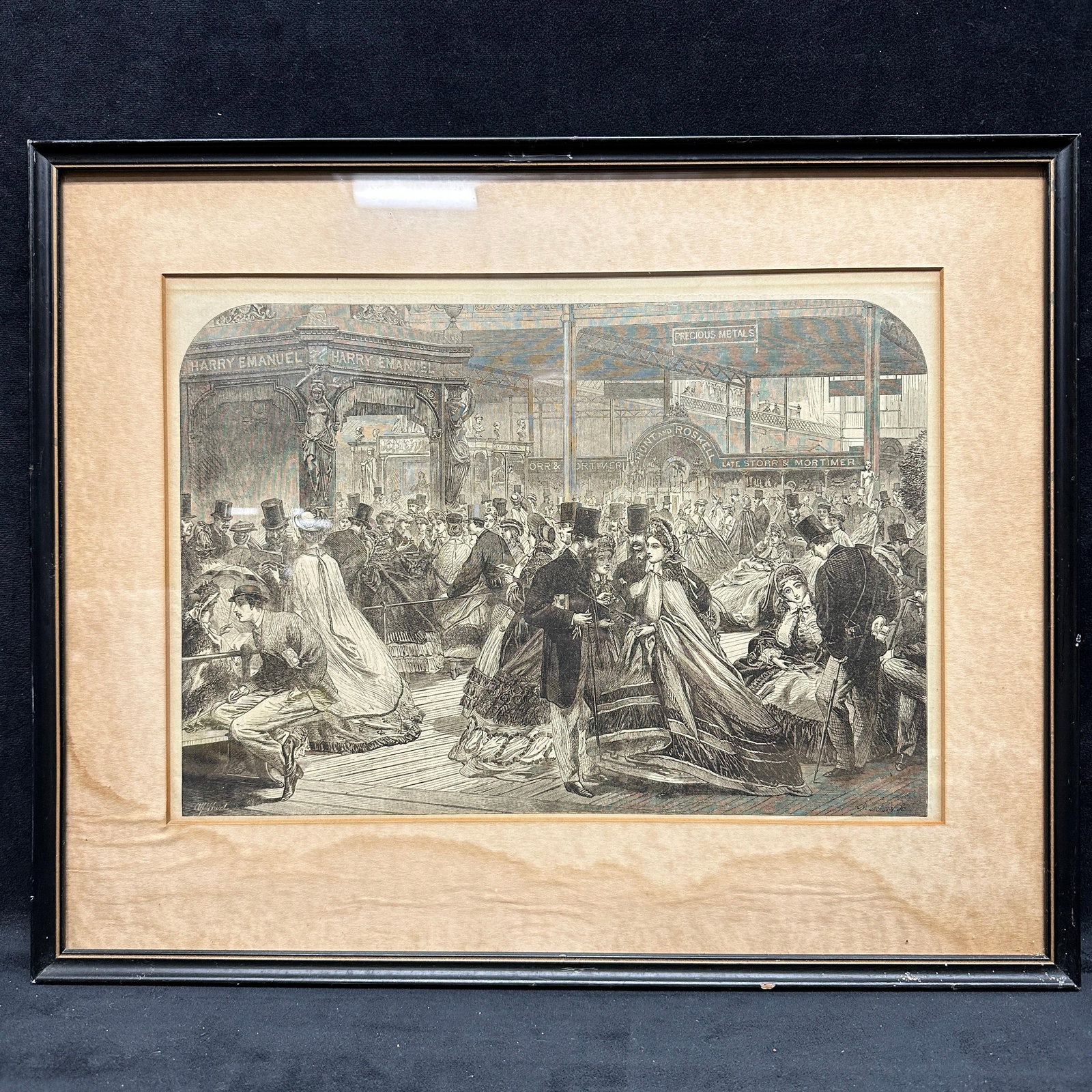 International Exhibition Hall Crowd Scene Framed Engraving Art Print: Black and white engraving depicting a busy Victorian era International exhibition hall with crowds in formal dress, including figures in top hats and gowns. Architectural setting with signage and disp