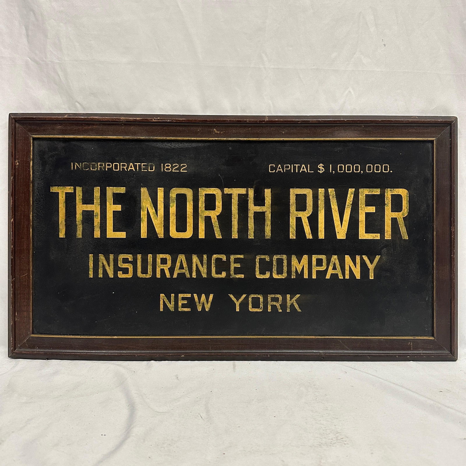 Early North River Insurance Company New York Tin Advertising Sign: This is a vintage early New York Insurance tin sign with gold-tone lettering in an original wooden frame. This vintage piece is in pre-owned, previously displayed condition with noticeable wear and su