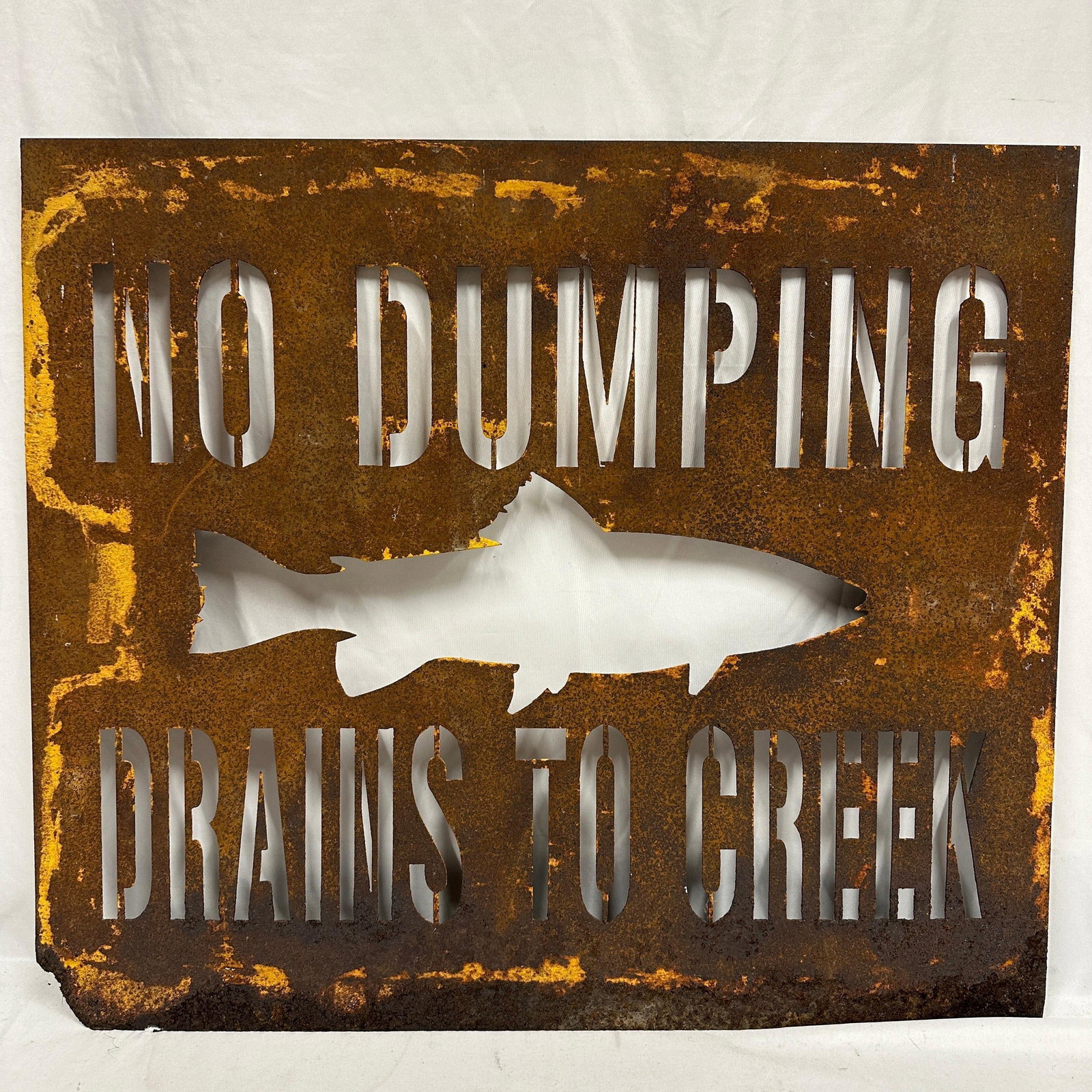 Rustic No Dumping Drains To Creek Cut Steel Warning Metal Sign: Rustic cut steel “No Dumping Drains To Creek” warning sign featuring fish silhouette cutout design. Heavy gauge steel construction with natural oxidized patina and weathered finish through
