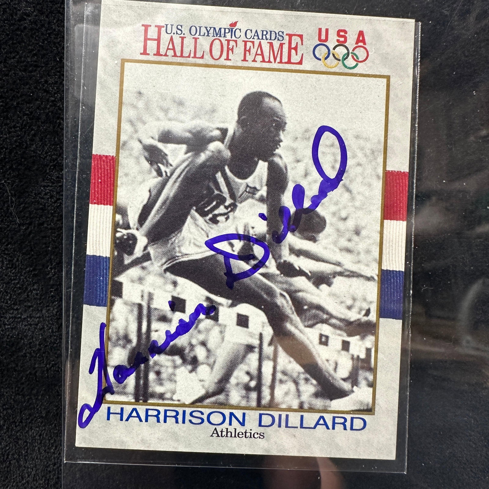 Harrison Dillard Signed US Olympic Hall Of Fame Trading Card: Signed U.S. Olympic Hall of Fame USA trading card featuring Olympic track and field athlete Harrison “Bones” Dillard. Signed in blue felt-tip marker. The card displays Dillard hurdling