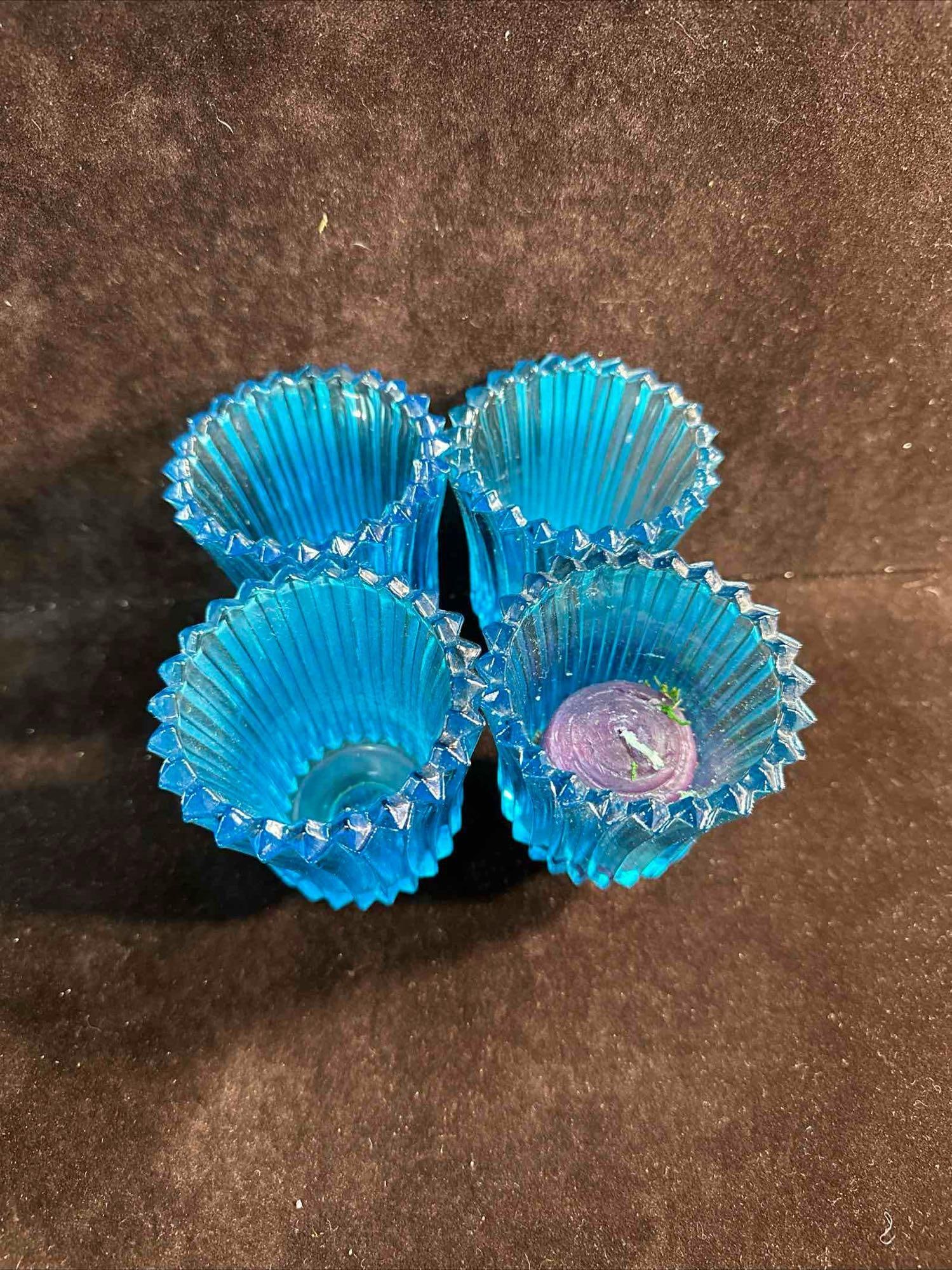 Blue Glass Ribbed Aqua Peg Votive Cup Candle Holder Set: Blue Glass Ribbed Aqua Peg Votive Cup Candle Holder Set. This aqua blue ribbed glass candle holder set features a pegged bottom. One purple tea light candle still inside one holder. No markings or ide