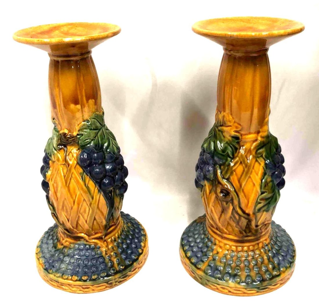 Set Of Two Large Ceramic Candlesticks With Grape Design: This lot contains a set of two large ceramic candlesticks with a matching grape and vine design on each. Each candlestick is approx 10 3/4" x 5 1/2". Together the set weighs about 1.2lbs. The candlest