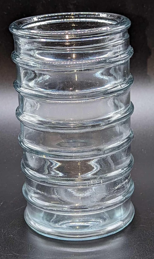 Vintage Clear Glass Ribbed Vase: Vintage Clear Glass Ribbed Vase. This is approx 3 1/2" x 3 1/2" x 6 1/4" and it weighs 1.11lb. The vase has some smudges from use.