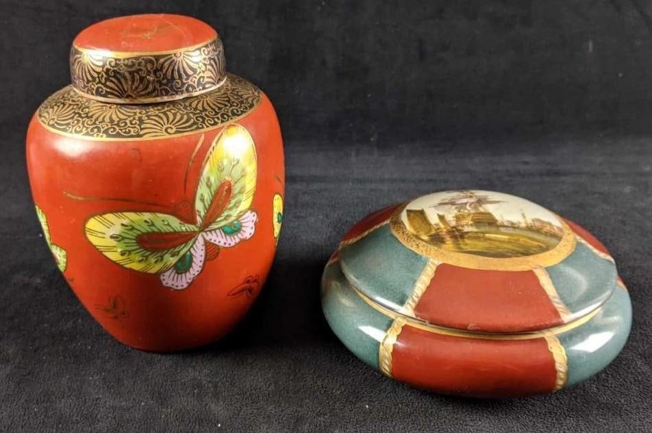 Decorative Lidded Jars with Gold Accents: Decorative Lidded Jars with Gold Accents This lot comes with two small decorative jars. Each jar has a different design such as the taller jar having butterflies over a red background. The other jar i