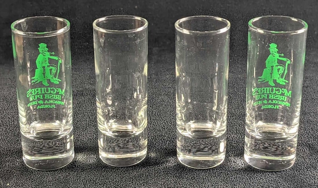 Four Shooter Shot Glasses Blank & McGuire's Irish Pub: This lot includes two blank shooter shot glasses and two from an Irish Pub named McGuire's. This was located in Pensacola and Destin Florida. The shooters are approx 1 1/2" x 1 1/2" x 4" and they