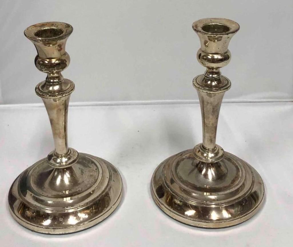 Pair Of Silver Plated Candlesticks Made In Japan: Pair Of Silver Plated Candlesticks Made In Japan. This lot contains a pair of silver plated candlesticks made in Japan. Each candlestick is approx 4 1/4" x 4 1/4" x 7" and together they weigh abo