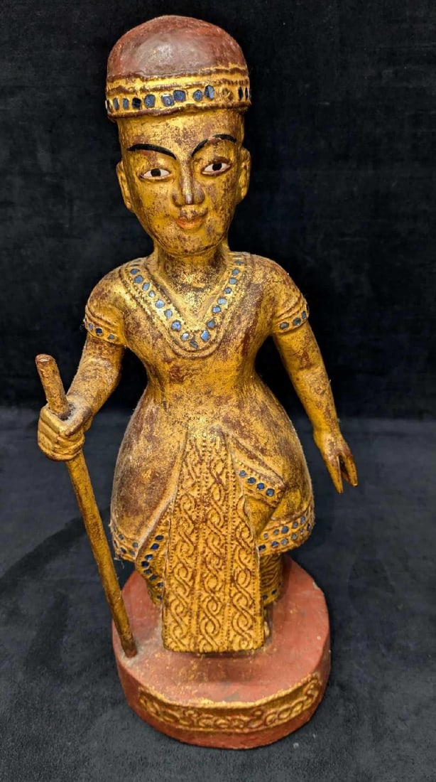 Vintage Thai Or Burmese Carved Gilt Wood Temple Guardian With Staff: Vintage Thai Or Burmese Carved Gilt Wood Temple Guardian With Staff. This is approx 7"x 7" x 17 5/8" and it weighs 5.30lb. The statue has some chips and cracks. Please see the images as they are part