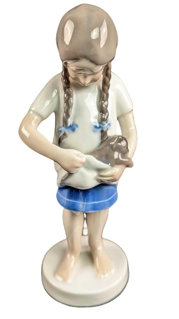 Royal Copenhagen Porcelain Girl With Kitten Figurine: Royal Copenhagen Porcelain "Little Mother", Girl With Kitten Figurine. The figurine is approx 3" x 2" x 6 3/4" and it weighs 0.45lb. The figurine is in a good, used condition with a small chip on the 