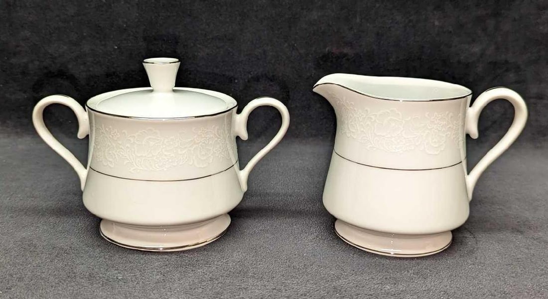 Retired International Juliet Creamer And Sugar Bowl: Retired International Juliet Creamer And Sugar Bowl. Made of a fine china. This lot includes: (1) Creamer. This is approx 4 3/4" x 3 5/8" x 3 1/2". (1) Sugar Bowl With Lid. This is approx