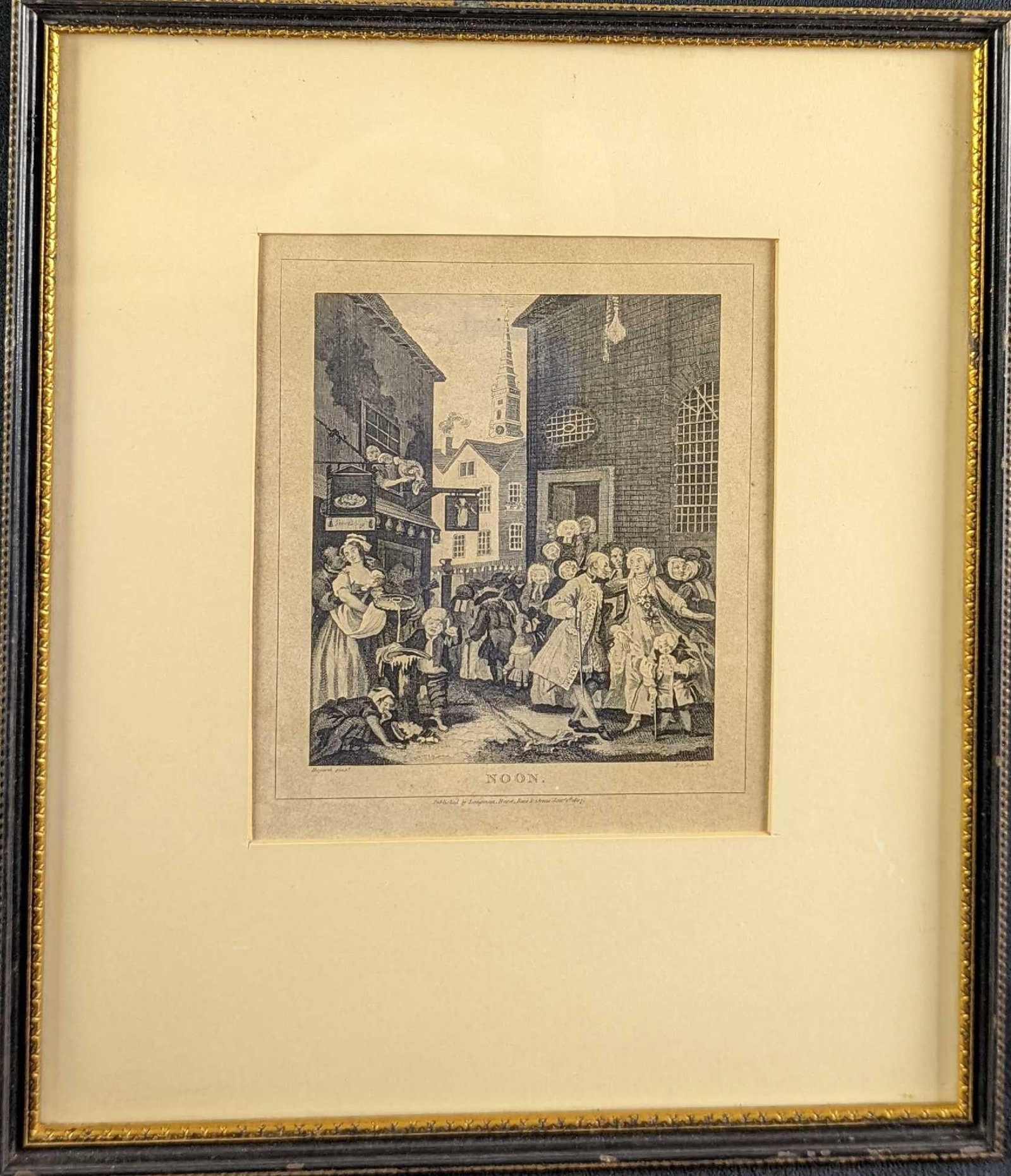 Framed Noon Engraving By T. Cook After W. Hogarth: The chain of destruction in front of the pub begins with the black man grabbing the breasts of the maid and ends with a child eating food that spilled onto the street. This engraving was published in 