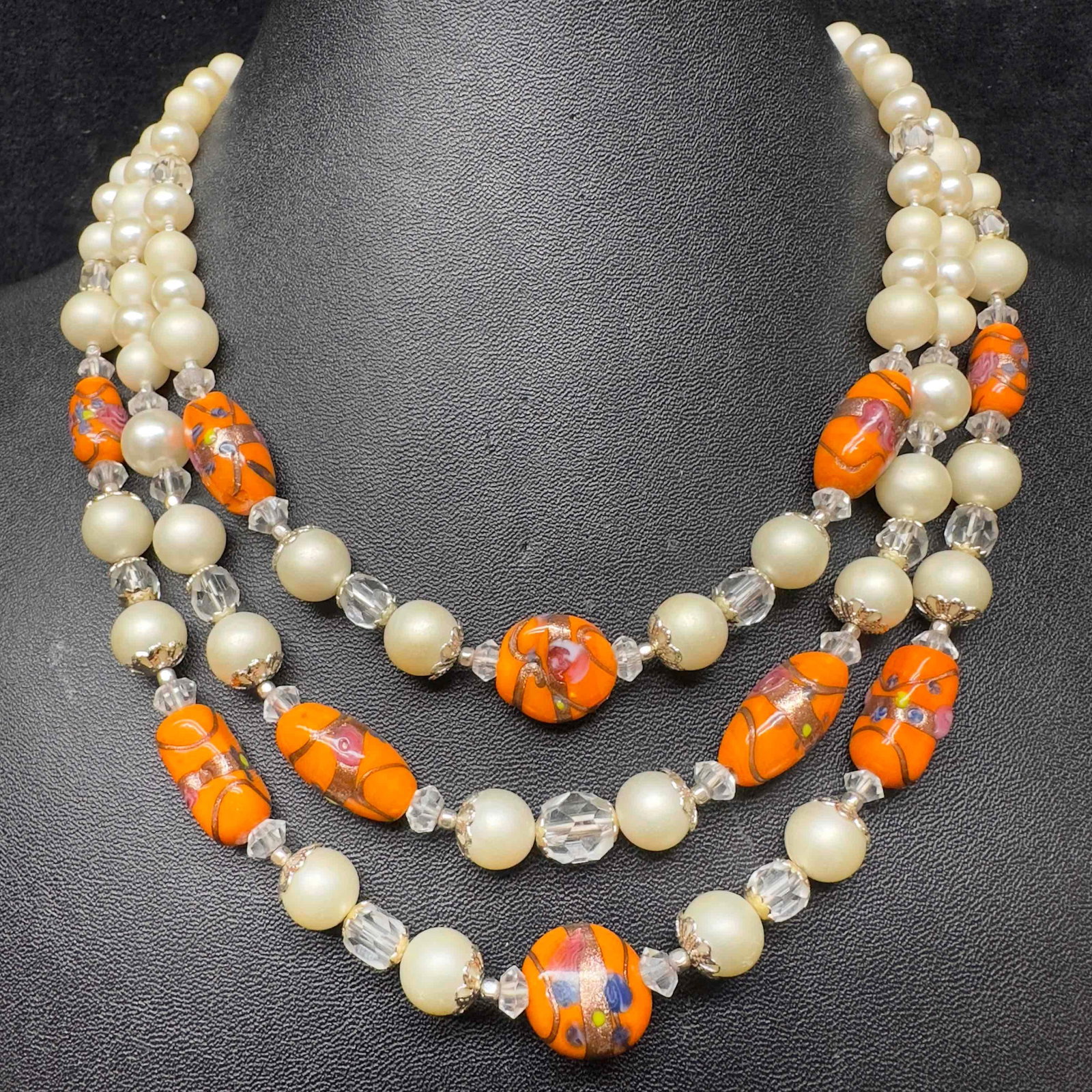 Venetian Murano Lamp Work Glass Art Orange Beaded Triple Layer Necklace G39: Venetian Murano Lamp Work Glass Art Orange Beaded Triple Layer Necklace G39. Necklace with orange colored glass beads with beautiful designs on each. The necklace has a copper colored accents. This tr