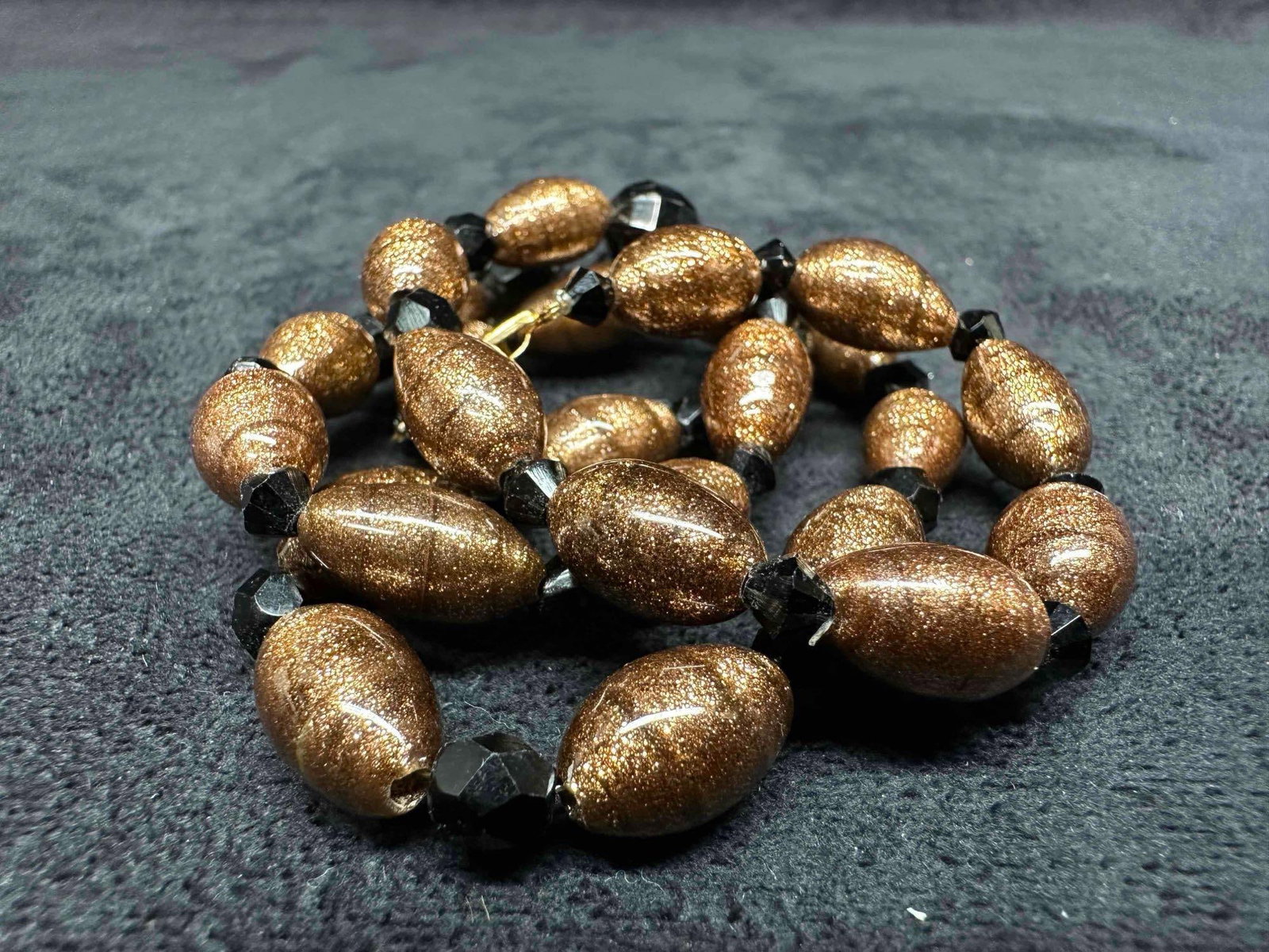 Murano Venetian Lamp Work Art Glass Copper Bead Black Beaded Accents Necklace G49: Murano Venetian Lamp Work Art Glass Copper Bead Black Beaded Accents Necklace G49. Necklace with copper colored glass beads with beautiful designs on each. The necklace features black beaded accents. 
