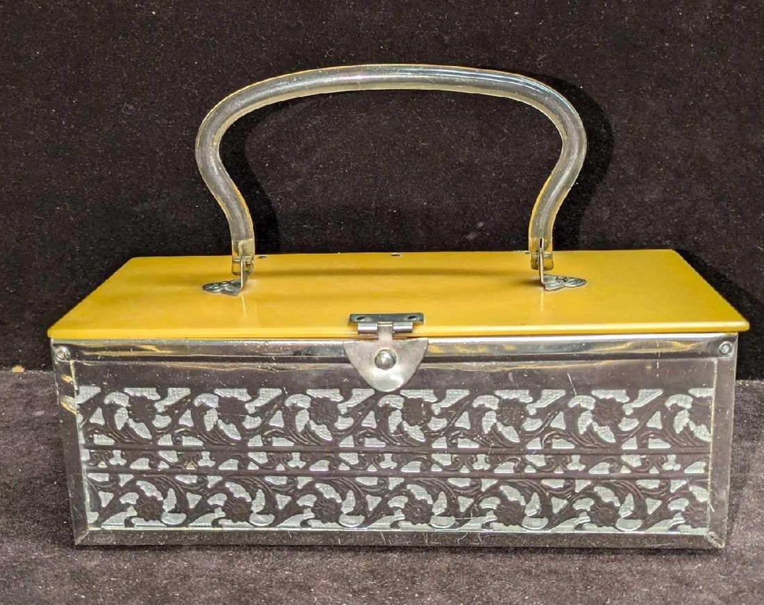 Vintage Metal Cutout Lucite Handle Jewelry Box: Vintage Metal Cutout Lucite Handle Jewelry Box. This is approx 9 1/8" x 3 1/2" x 3 3/4" and it weighs 1lb. The box has some scratches and signs of wear.
