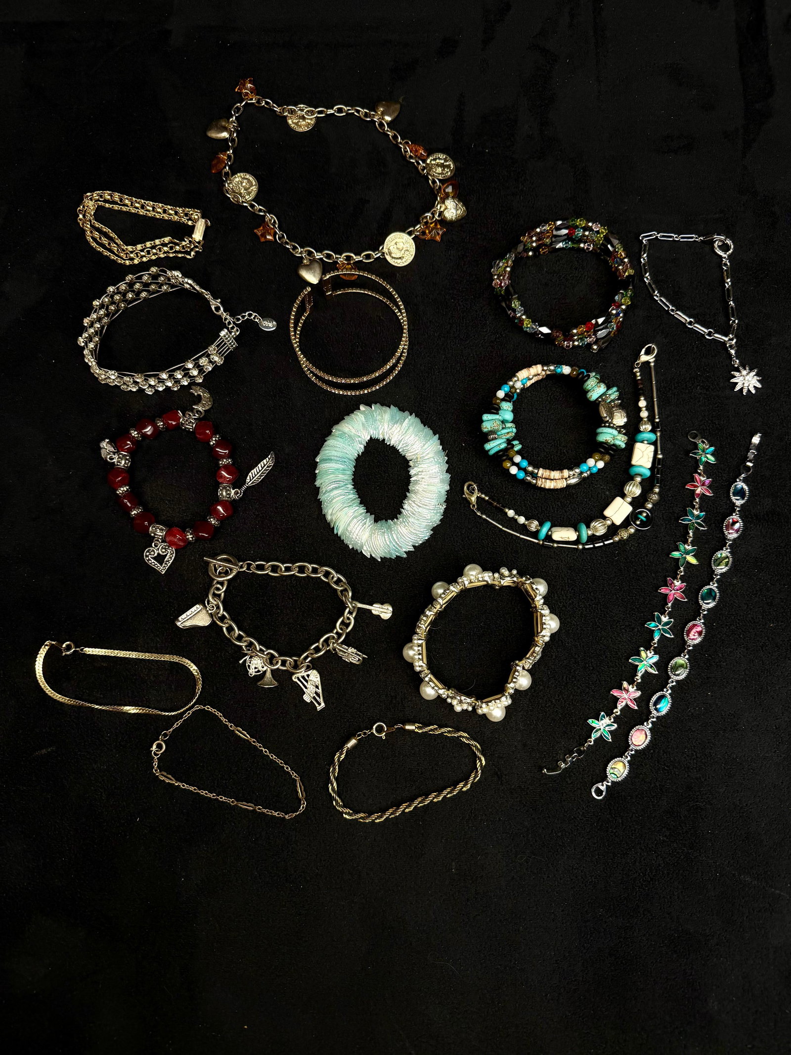 Assorted Vintage and Modern Costume Jewelry Bracelet Collection Lot of 17: A vibrant and varied collection of seventeen (17) costume jewelry bracelets, including a mix of vintage and contemporary styles. The lot features an assortment of gold and silver-tone pieces, beaded s