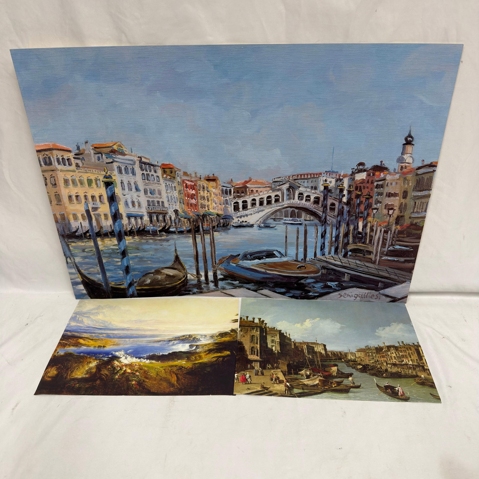 Venice Rialto Bridge Art Reference Prints Set of Three Variety: Artwork and reference prints depicting Venice’s Grand Canal with the Rialto Bridge, gondolas, boats, and surrounding Venetian architecture. These items are in pre-owned, previously used/dis