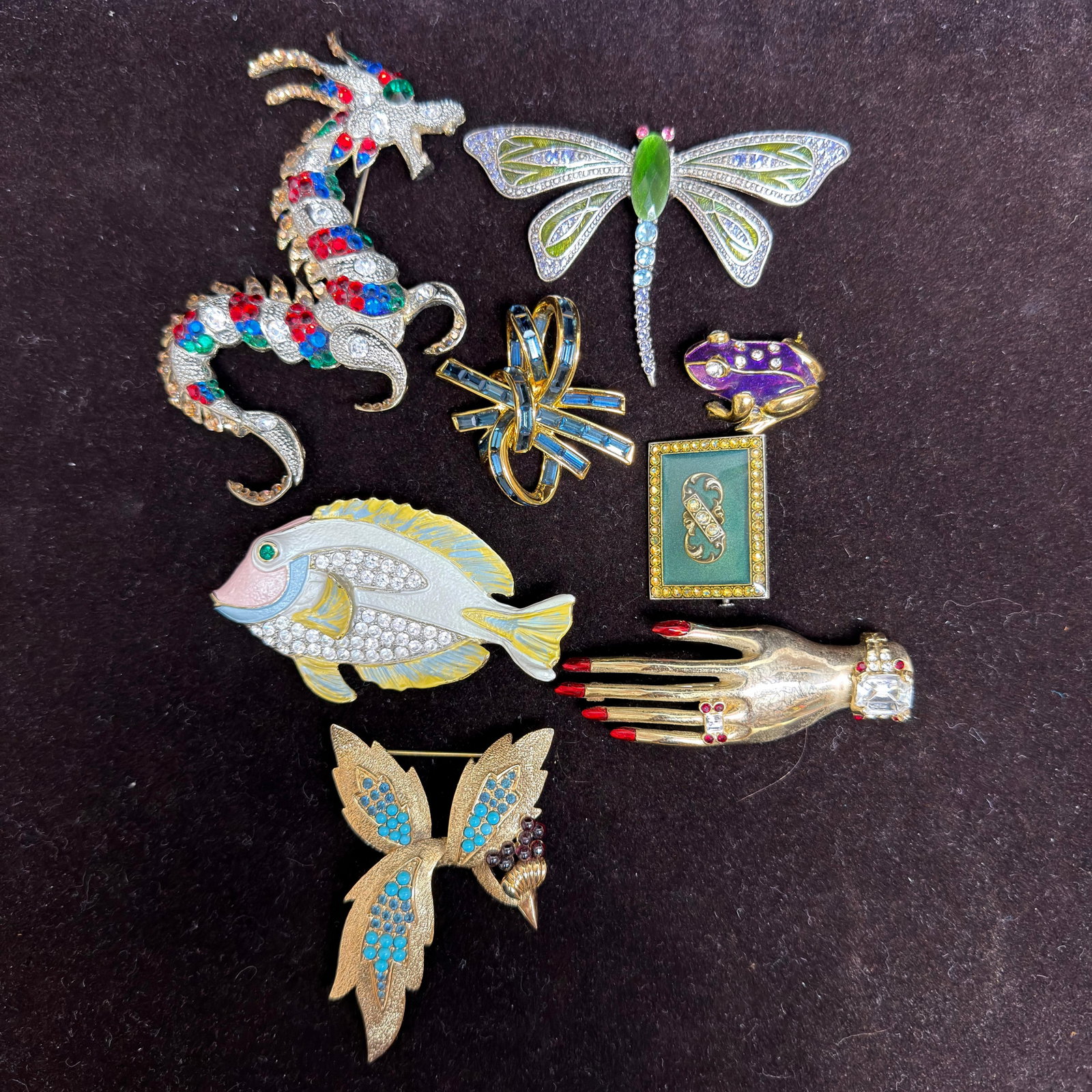 Vintage Set of Costume Jewelry Brooches Dragon Fish Dragonfly Figural Designs 8 Pcs: Eight-piece collection of vintage costume jewelry brooches featuring a colorful rhinestone dragon, enamel and rhinestone dragonfly with green cabochon body, blue rhinestone ribbon bow, purple enamel f