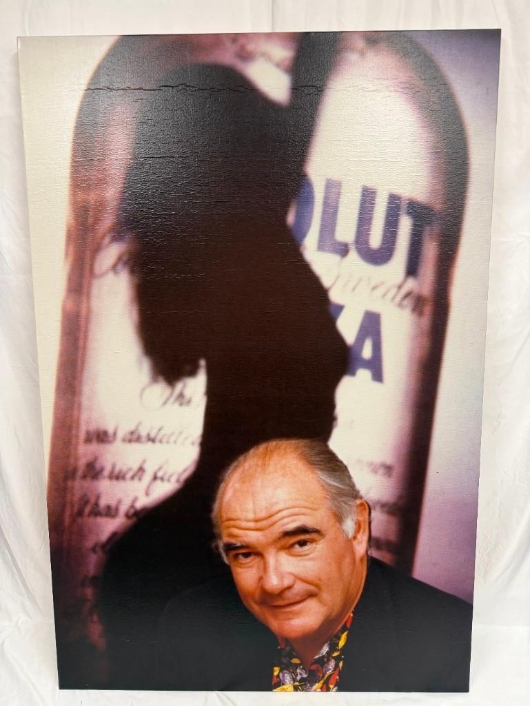 Woman Silhouette and a Portrait of Michel Roux Absolut Vodka Canvas Print Artwork: This image artwork print on canvas appears to be a promotional advertisement for Absolut Vodka featuring a woman's silhouette and a portrait of Michel Roux. This item is in pre-owned, previously d
