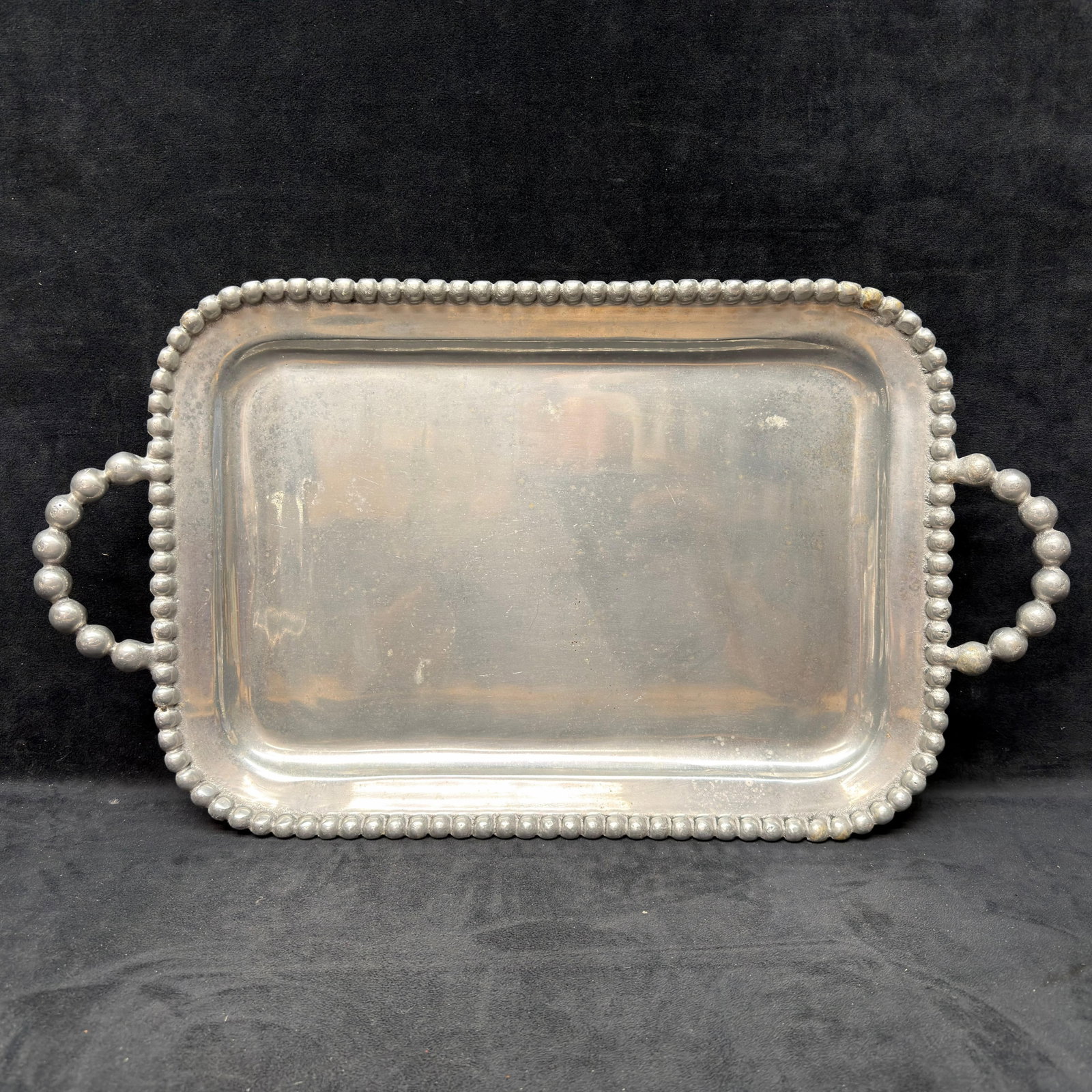Mariposa Pearled Medium Service Tray Silver Tone Aluminum Serving Platter: Mariposa cast aluminum serving tray featuring the maker's signature beaded border and matching beaded side handles. Marked Mariposa and dated 2000 on the underside. Simple rectangular form with