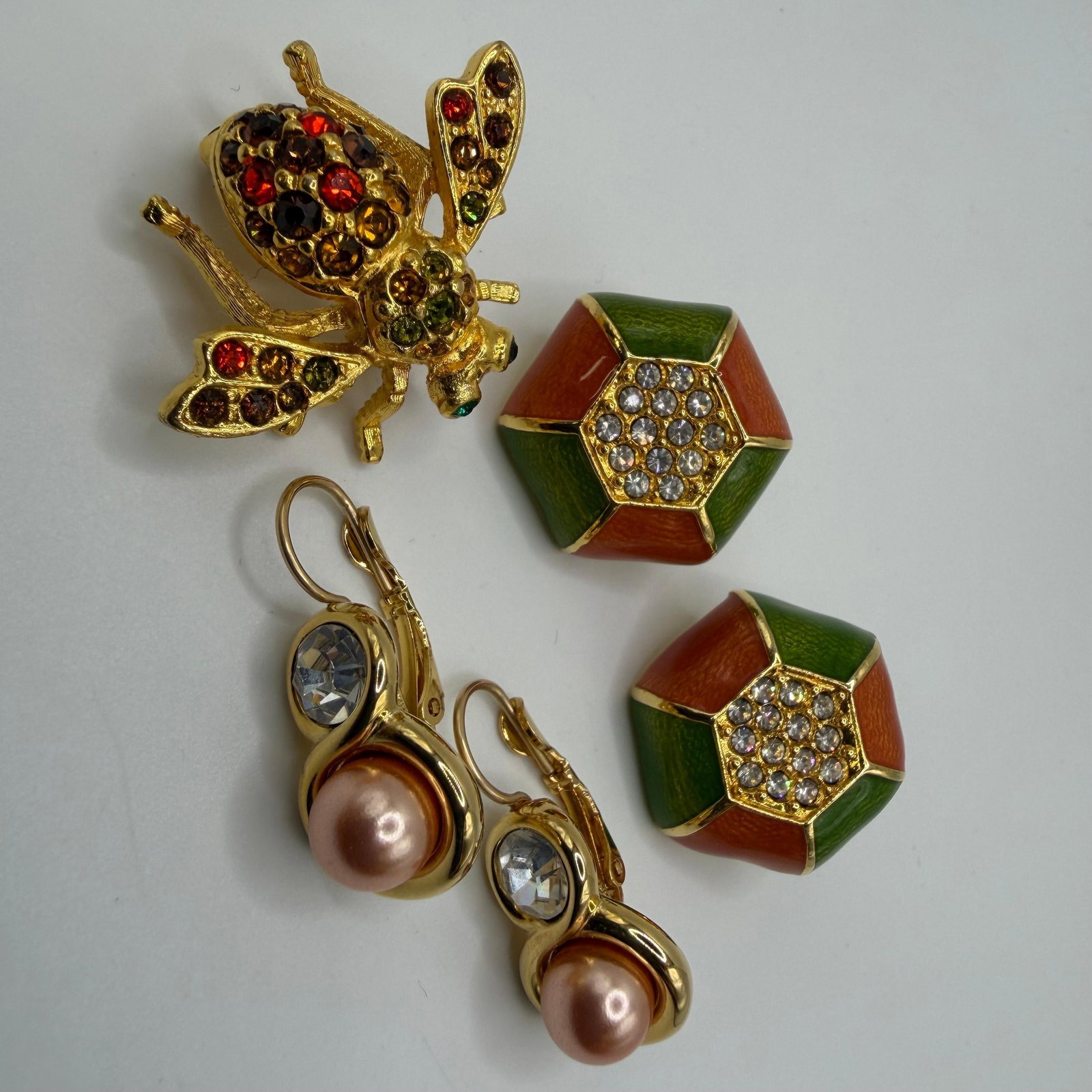 Joan Rivers Enamel Faux Pearl Drop Earrings and Crystal Bee Brooch HH23: Joan Rivers costume jewelry assortment includes a multicolor crystal bee brooch accented with amber, green, and red stones, a pair of geometric green and rust enamel earrings with crystal centers, and