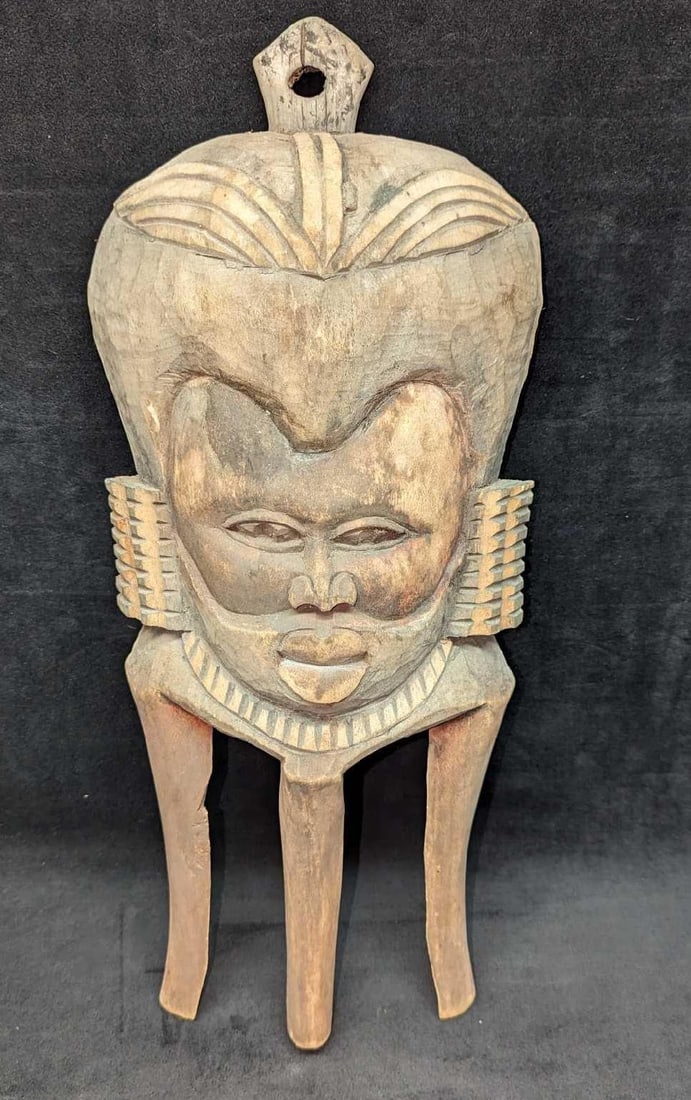 Vintage Hand Carved Wood Zimbabwe Wall Art Mask: Vintage Hand Carved Wood Zimbabwe Wall Art Mask. This is approximately 8" x 2 1/2" x 19 1/2" and it weighs 0.96lb. The mask has some chips. Please see the images as they are part of the description.