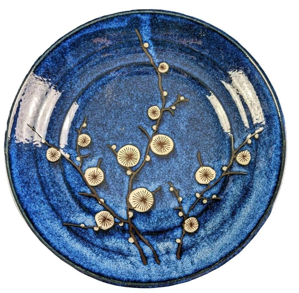 World Market Cherry Blossom Fine China Serving Bowl: World Market Cherry Blossom Fine China Serving Bowl. Bring Asian-inspired elegance to your table with our cherry blossom-adorned dinnerware. Handcrafted in Japan with a blue glazed finish over a grace