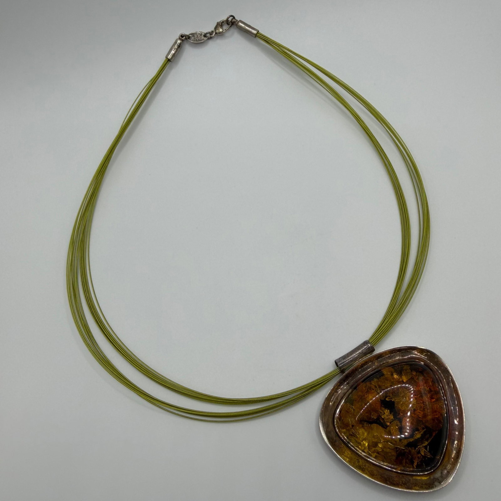 V8 Poland Green Cord Sterling 925 Large Amber Pendant Necklace: This item is in pre-owned, previously used/displayed condition with noticeable light wear and surface scratches. Please reference all photos for full details. This piece of jewelry has been tested and