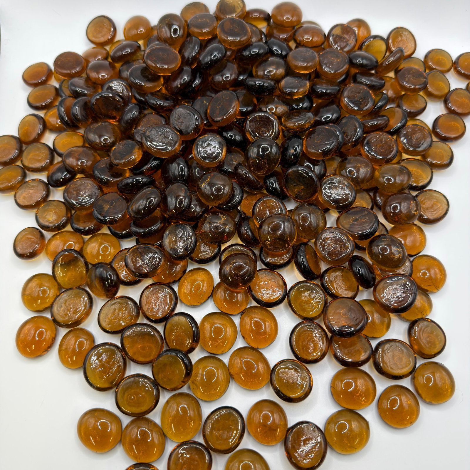 Lot of 275 Amber Brown Decorative Glass Gems Vase Fillers and Mosaic Stones: Large lot of approximately 275 amber and dark amber decorative glass gems. Smooth, rounded flat-back glass stones suitable for floral arrangements, vases, aquariums, crafts, mosaics, candle displays, 