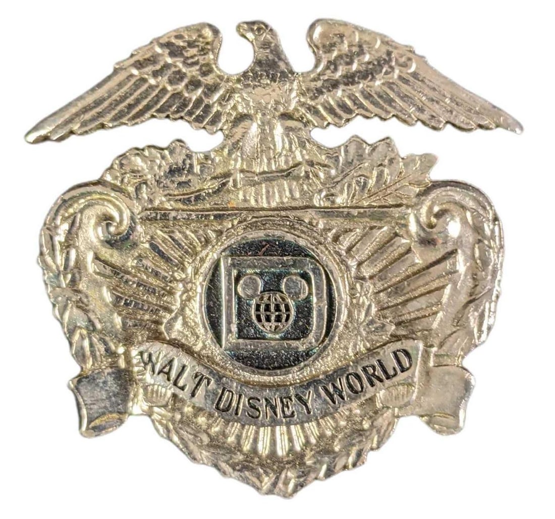 Vintage 1970s Walt Disney World Hat Security Badge: Vintage 1970s Walt Disney World Hat Security Metal Badge. Is approx 2 1/2" x 2/1" and weighs under one pound at 0.07lb. The badge is in a good, vintage condition with some wear and is missing the hook