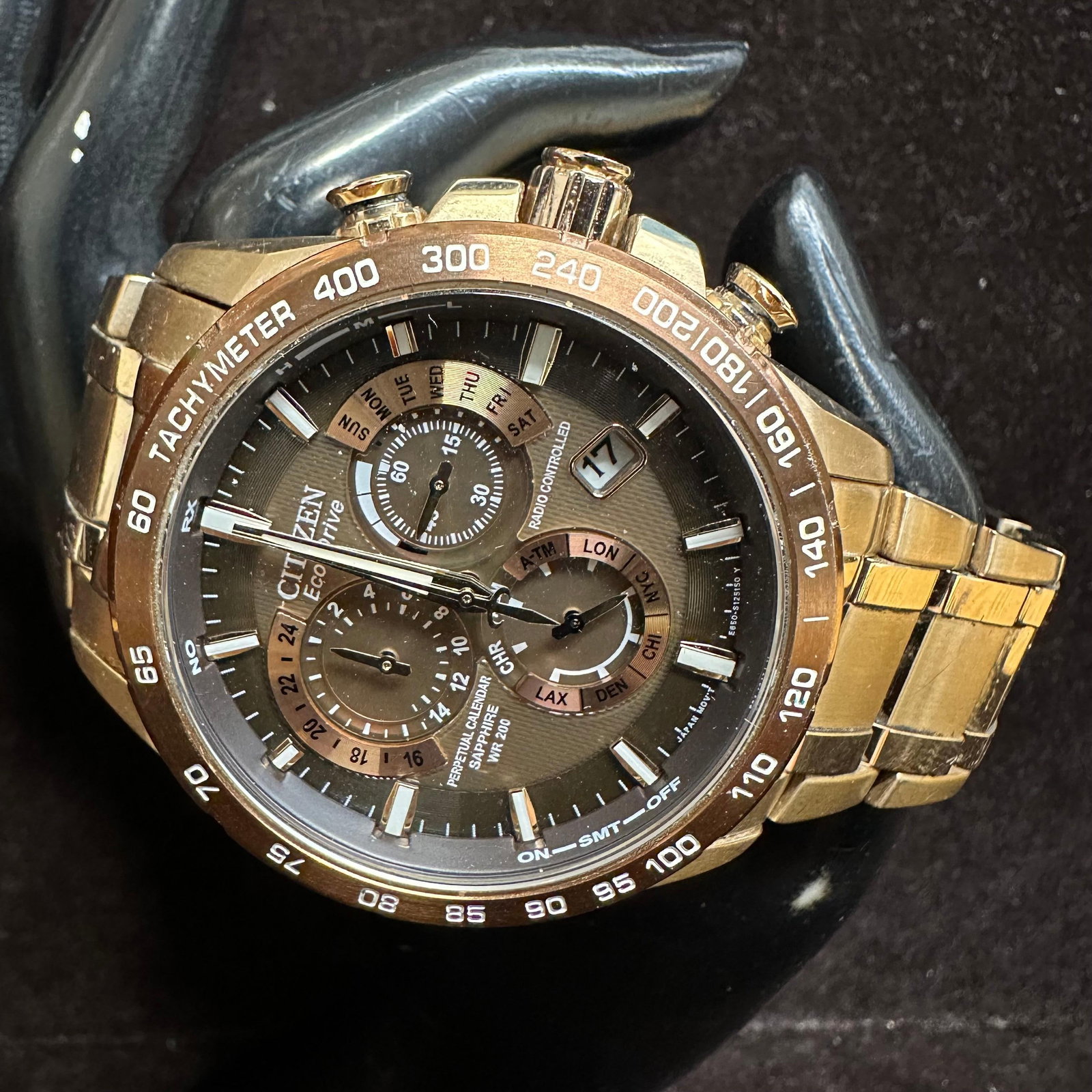 Citizen Eco-Drive Perpetual Chrono A-T Watch AT4106 Wristwatch: Citizen Eco-Drive men’s wristwatch with gold-tone stainless steel case and bracelet. Brown dial with tachymeter bezel. Features include radio-controlled timekeeping, perpetual calendar, world ti