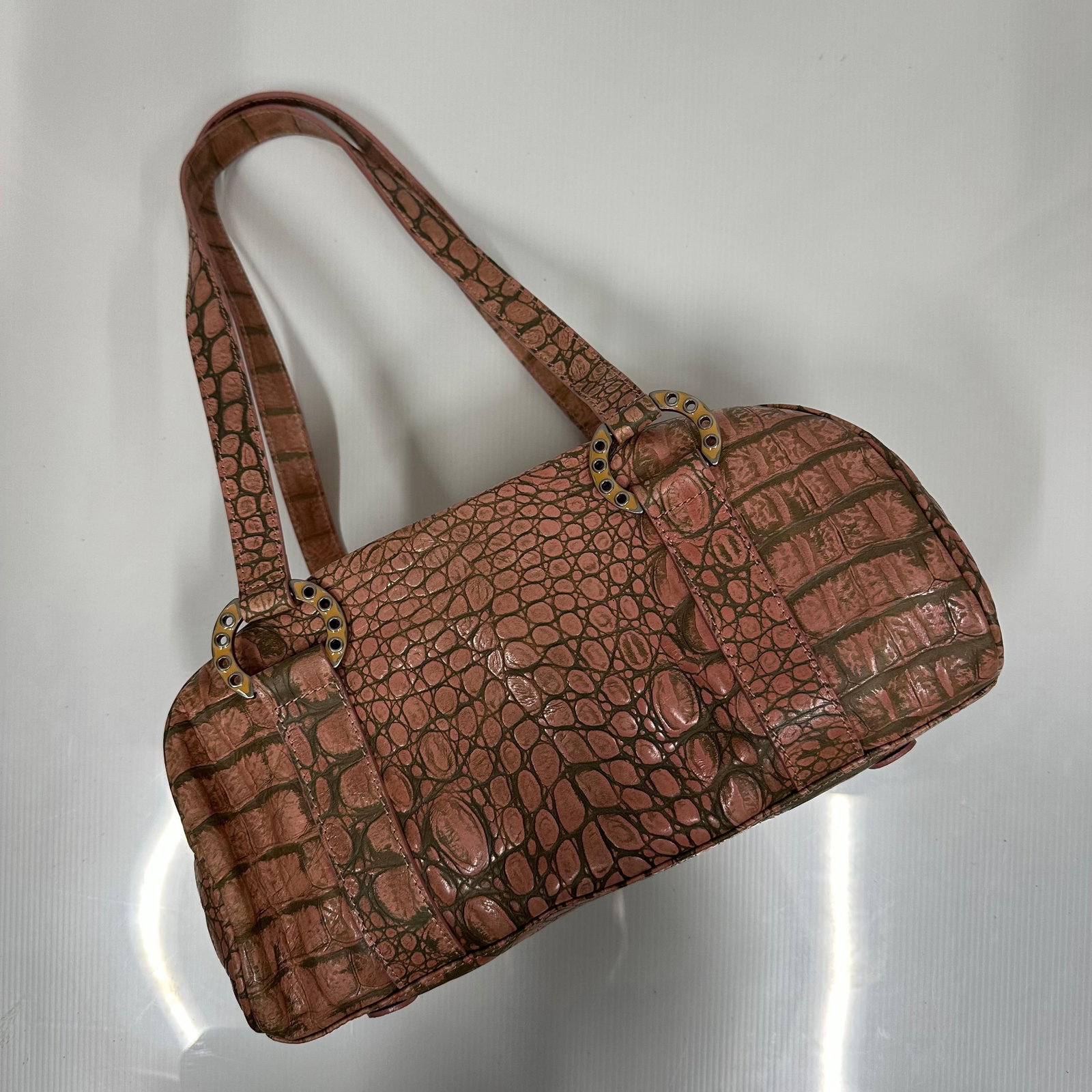 Donald J. Pliner Couture Faux Croc Embossed Leather Handbag Made in Italy: Donald J. Pliner Couture handbag featuring faux croc embossed leather in a pink/bronze tone with contrasting darker veining. Double shoulder straps with decorative metal ring hardware. Zip top closure