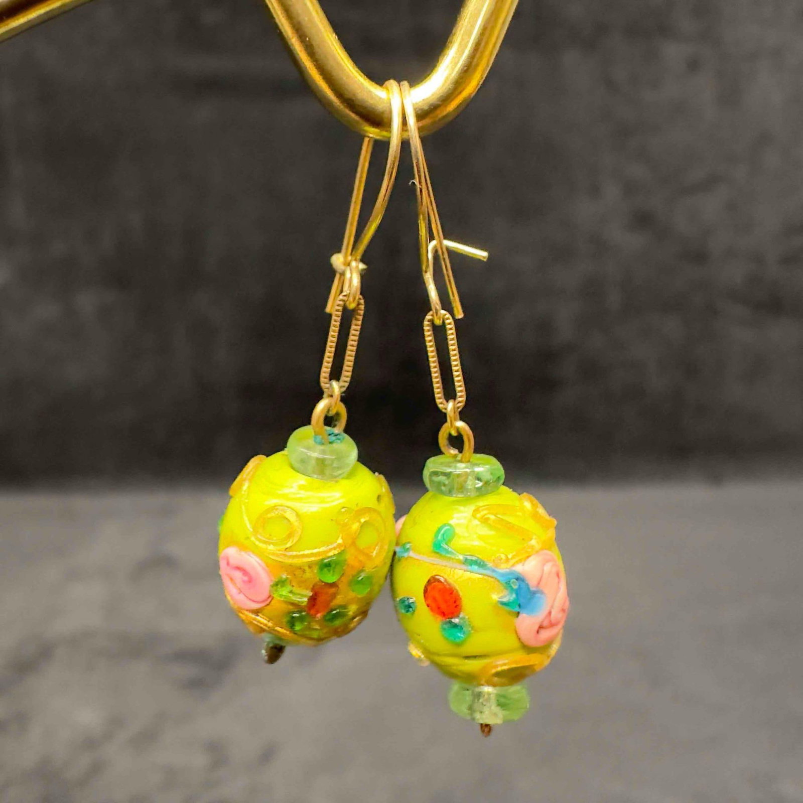 Murano Venetian Art Glass Lamp Work Light Green Floral Dangle Earrings D75: Murano Venetian Art Glass Lamp Work Light Green Floral Dangle Earrings D75. Earrings with light green glass beads with beautiful designs on each. The earrings feature gold colored and floral accents. 