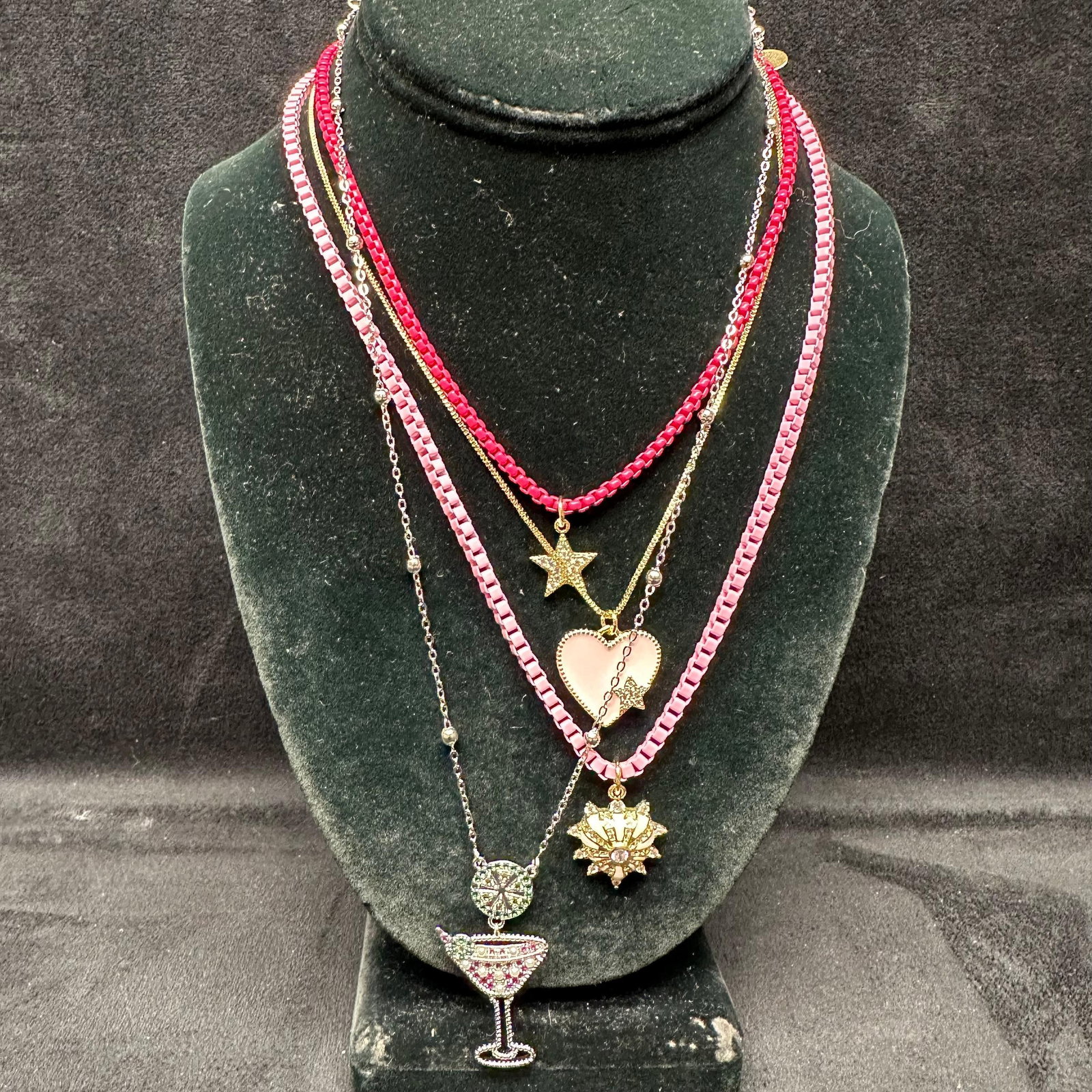 Melania Clara Assorted Necklace Set Martini Heart Star Motifs L98: The Melania Clara and Alexa Rae necklace set features a magnet clasp closure. The necklaces have magnet extender clasp closures. Each necklace showcases modernist designs with gold-toned and