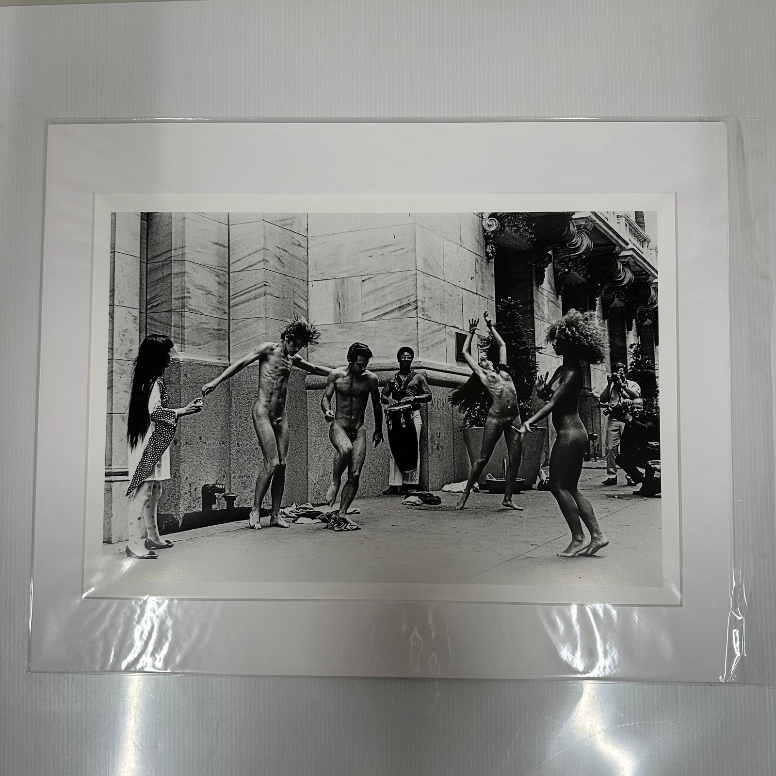 Yayoi Kusama Body Festival Black and White Nude Photo Print Medium Matted: Medium Black and white photographic print depicting Yayoi Kusama’s nude performance happening (Body Festival) outside a New York City building, circa late 1960s. The image shows dancers and onlo