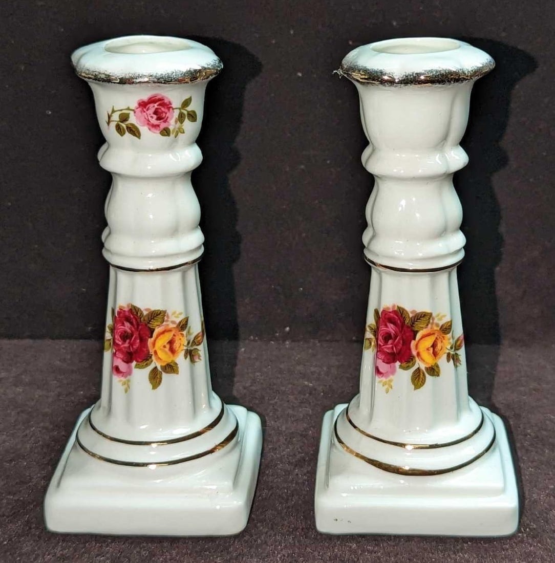 2 Brinn's Fine Bone China Cottage Rose Candlestick Holders: 2 Brinn's Fine Bone China Cottage Rose Candlestick Holders. Each is approx 2" x 2" x 5" and the total weight is 0.44lb. The candlestick holders have no chips or cracks.