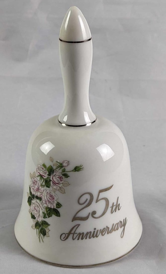 Papel 25th Wedding Anniversary Porcelain Bell: Papel 25th Wedding Anniversary Porcelain Bell. The bell is approx 3" x 3" x 5 1/2" and it weighs 0.28lb. The bell is in a good, used condition with some markings/residue inside the bell. The bell has