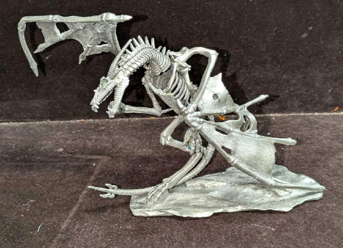 Rawcliffe Pewter Kaladrax Undead Dragon Figurine: Rawcliffe Pewter Kaladrax Undead Dragon Figurine. This is approx 8 1/2"x 4" x 5 3/4" and it weighs 1.07lb. The dragon is missing one of its faux crystal eyes. The top wing is also a little on the