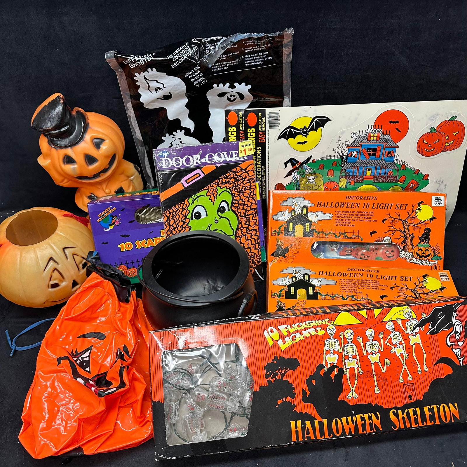 Group of Vintage Halloween Decorations Pumpkin Lanterns and Light Sets: Collection of assorted vintage Halloween decorations, including plastic pumpkin lanterns, decorative light sets, and paper and vinyl decorations. The lot includes two decorative Halloween 10-light set
