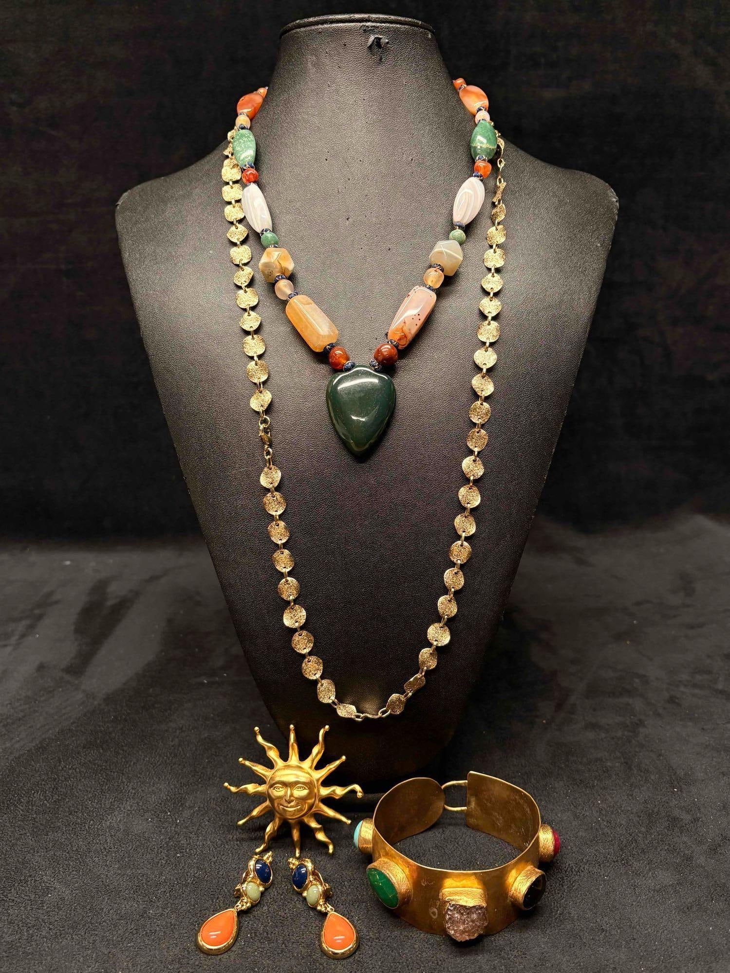 5pc Gold and Earth Tone Sun Child Themed Mixed Costume Jewelry Lot: This lot contains 5 pieces of costume jewelry, all of which in overall good condition with minor flaws due to age and use. Please refer to the images provided for full context of the lot's conditi