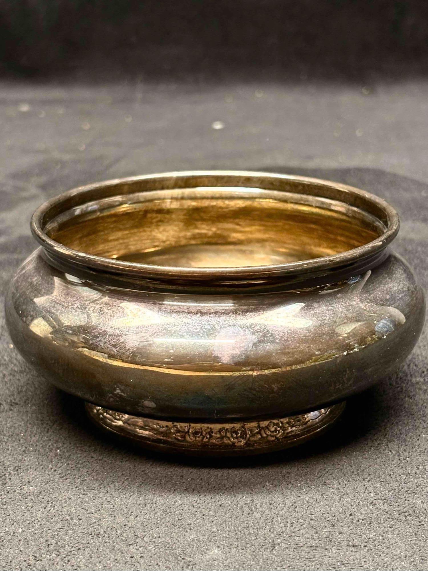 Camille 6005 International Silver Plated Sugar Bowl: The age of this lot can be seen in its finish. The bowl displays the affects of oxidization on its surfaces, the inside of the bowl discolored due to age. The bottom of the bowl possessess a stamp tha
