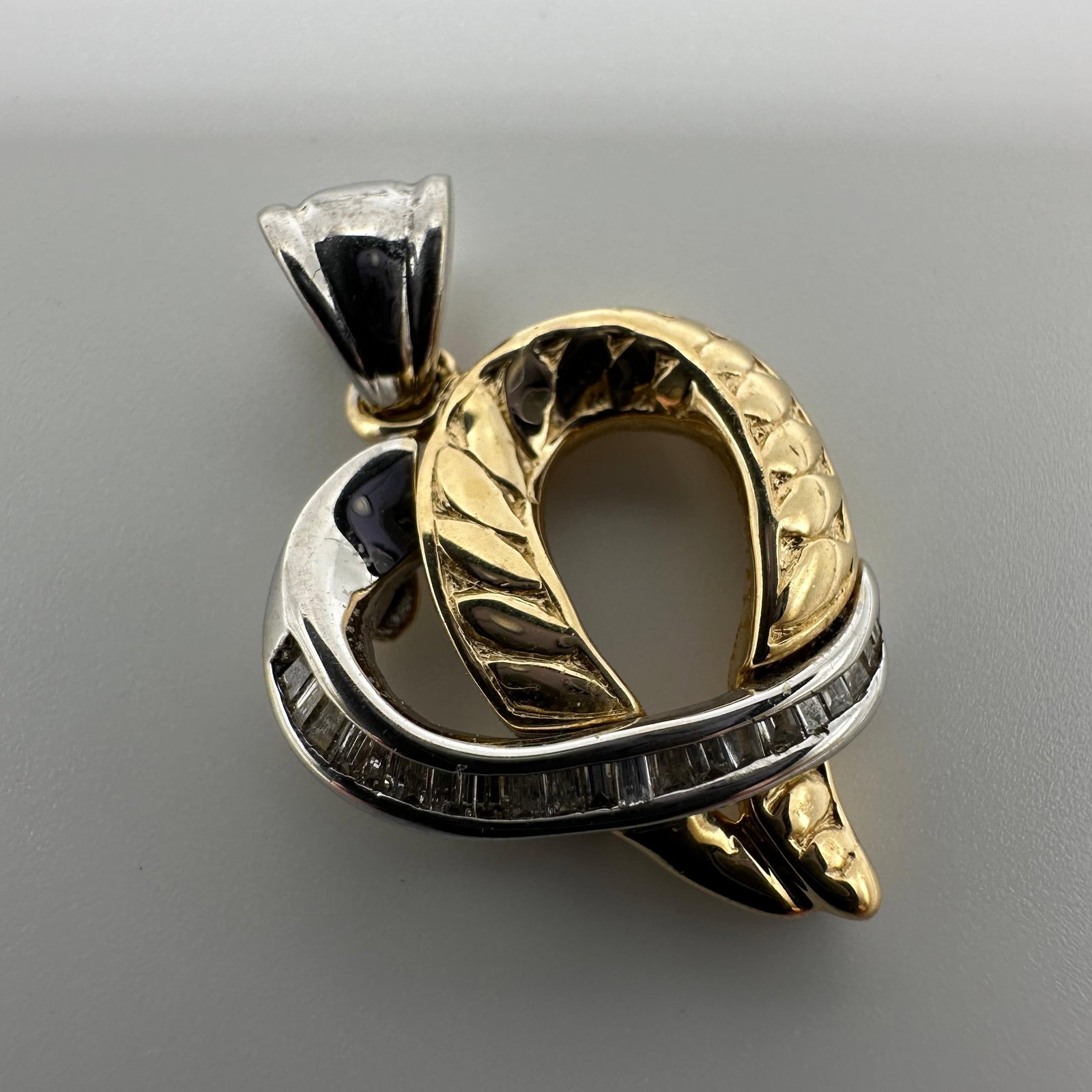 14K Gold Two Tone Wrapped Heart Baguette Diamond Pendant W84: This item is in good pre-owned, previously used/displayed condition with noticeable light wear and surface scratches. Please reference all photos for full details. This piece of jewelry has been teste