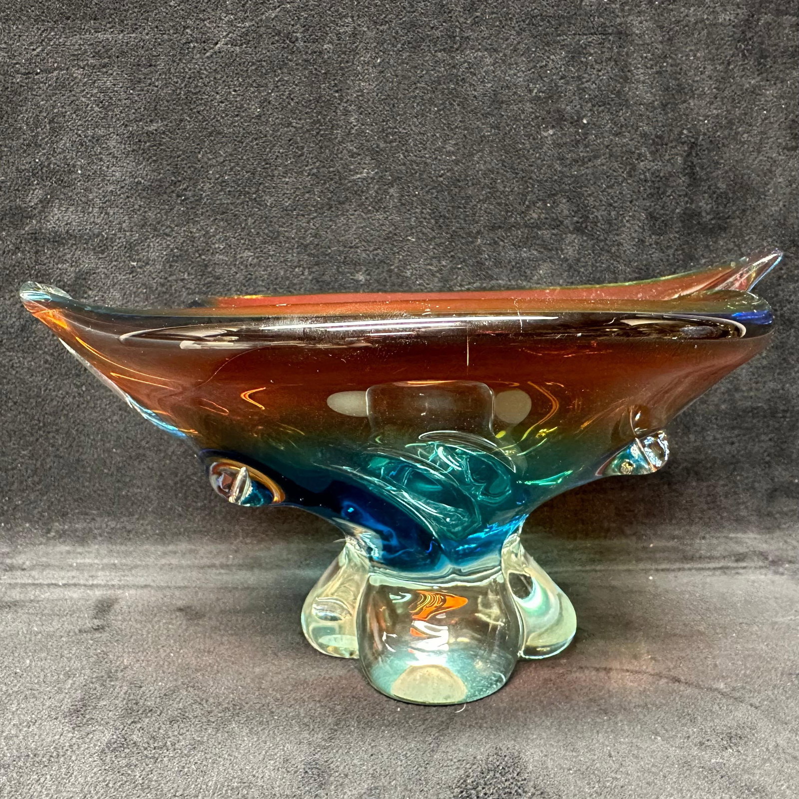 Murano Style Hand Blown Art Glass Footed Bowl with Sculptural Rim Amber Blue Colored: Hand-blown art glass bowl in the Murano style featuring a multicolor design with amber, teal, blue, and clear glass. The bowl has a sculptural, free form rim with flowing curves and applied details, s