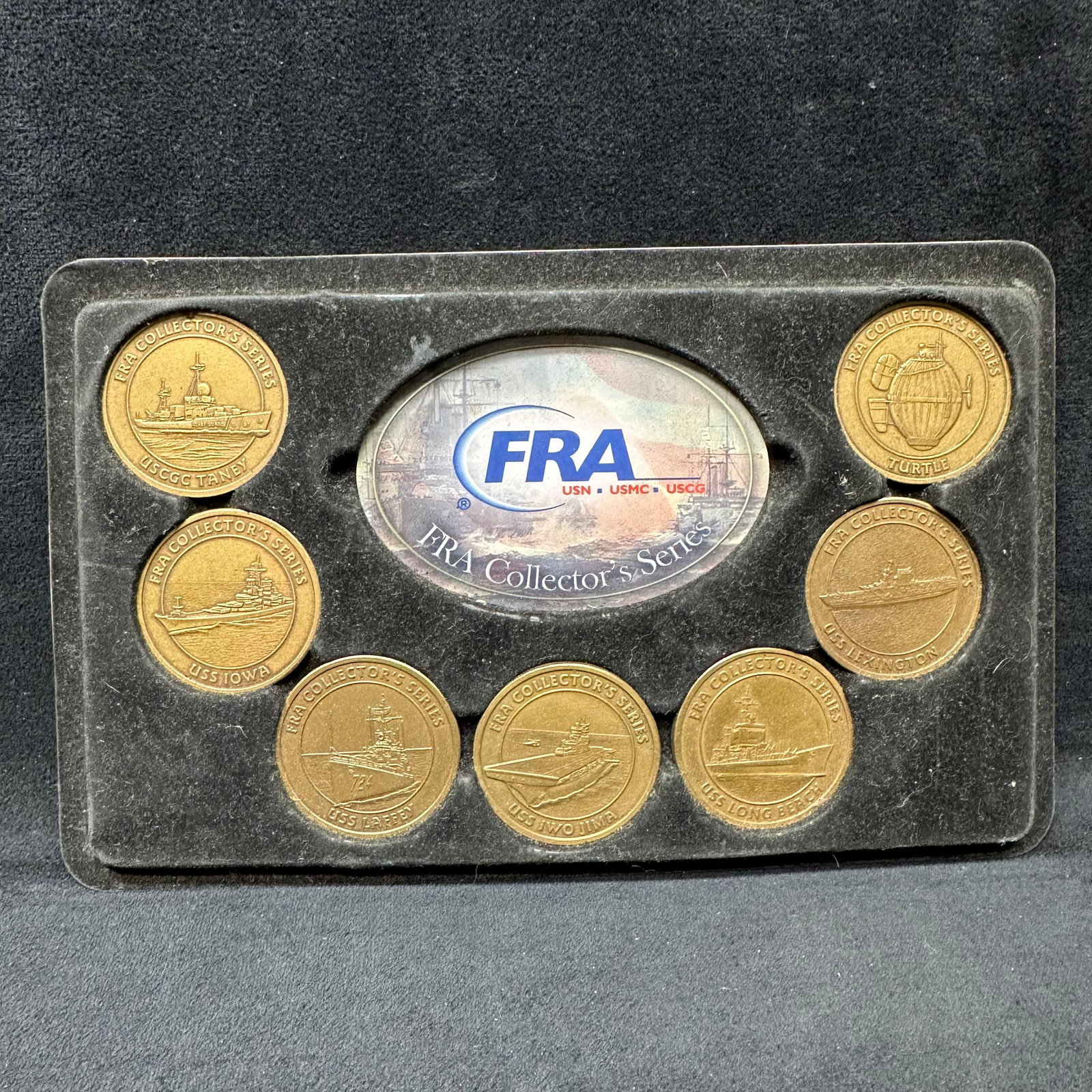 FRA Collector’s Series Military Medallion Set U.S. Navy and Coast Guard Vessels: FRA Collector’s Series commemorative medallion set featuring multiple military-themed brass-toned medallions. Includes U.S. Navy and U.S. Coast Guard subjects. Housed in the original FRA display