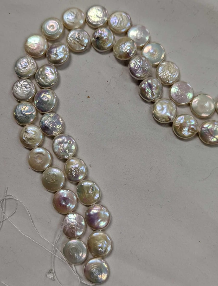 Two Natural Freshwater White Coin Pearls Bead Strands: Here we have a lovely lot of white coin pearls for those jewelry artists out there. This lot contains white coin pearls size 10mm, and the weight of the lot is 0.13lbs. It comes in a bag that is appro