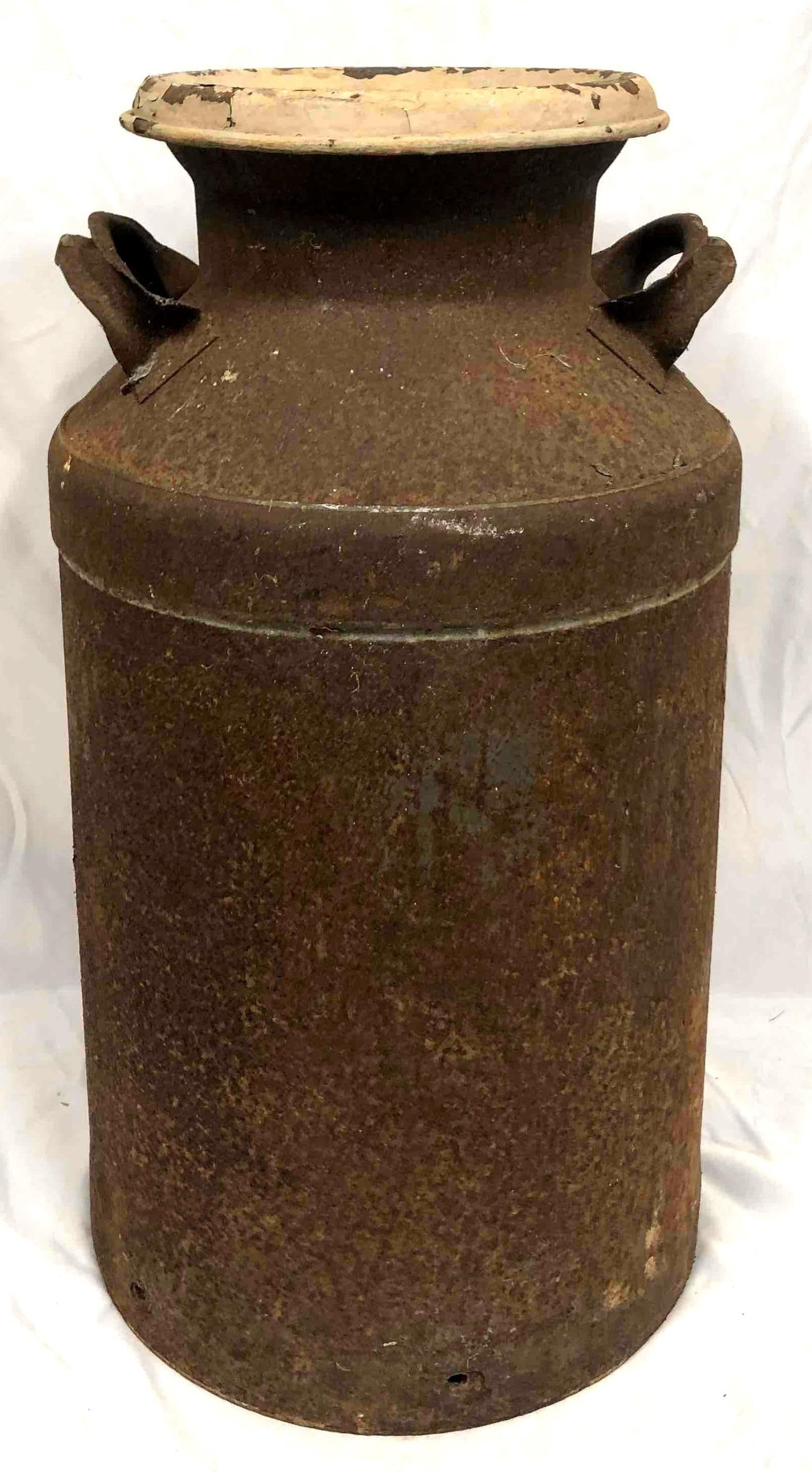 Vintage Milk Jug With Lid Metal/Rustic: This lot contains a vintage milk jug with a lid. The jug is a metal/rustic country aesthetic. Perfect for use as outdoor decor. It is approx 12 3/4" x 12 3/4" x 24" and weighs about 22.7lbs. Overall t