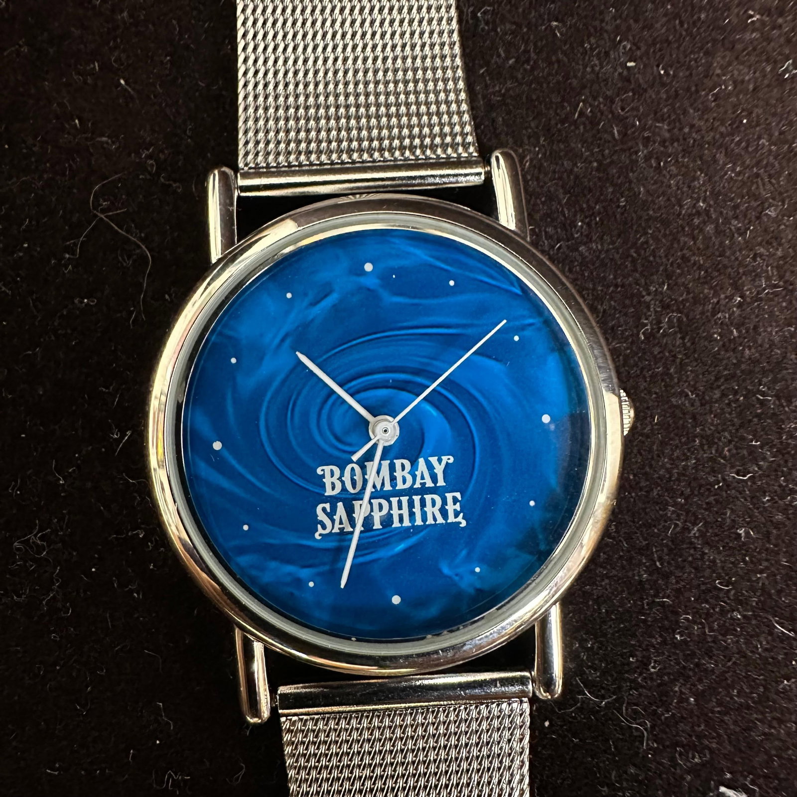 Bombay Sapphire Blue Stainless Steel Silver Tone Watch: Needs a new battery; has not been tested. This item is in pre-owned, previously displayed condition, with light wear and surface scratches. Please reference all photos for full details. Measurements: