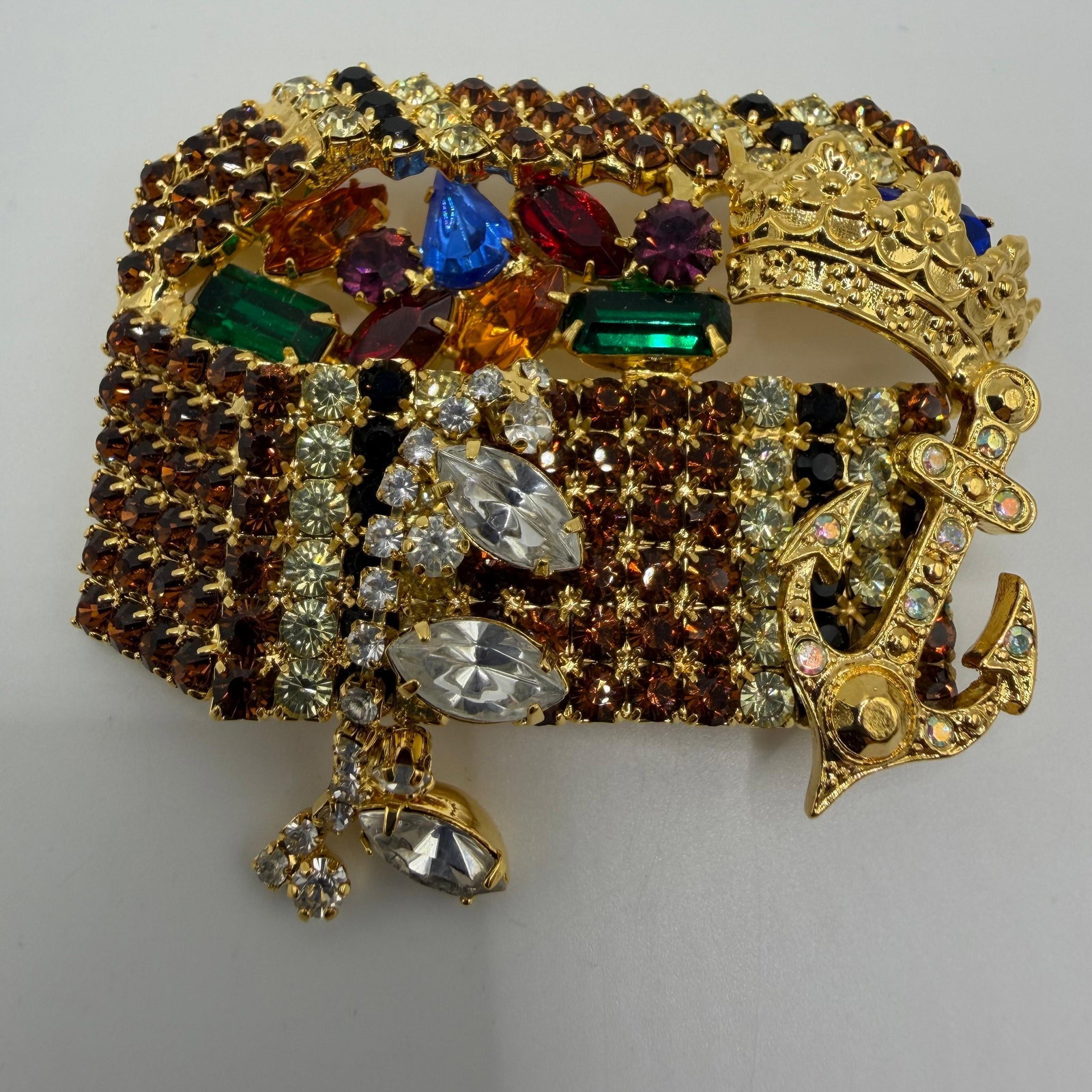 Kirks Folly Enchanted Treasure Chest Crystal Brooch: Signed Kirks Folly "Enchanted Treasure Chest" brooch featuring a richly detailed gold-tone treasure chest overflowing with multicolored faceted crystals and rhinestones. Accented with a jewele