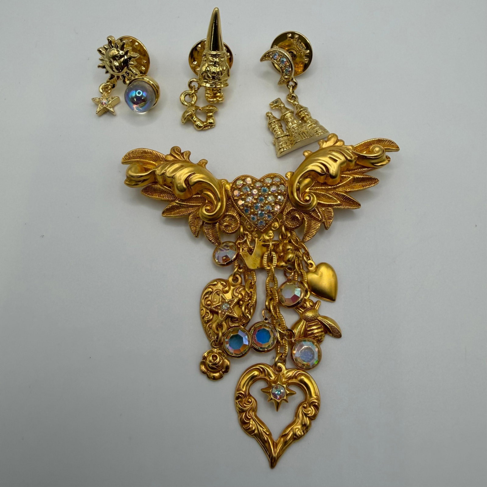 Kirks Folly Enchanted Heart Brooch with Fantasy Charm Pins: Bright whimsical fantasy design, Large signed Kirks Folly gold-tone brooch featuring a rhinestone-set heart centerpiece with cascading dangling charms including hearts, stars, bee, moon, rose, faceted