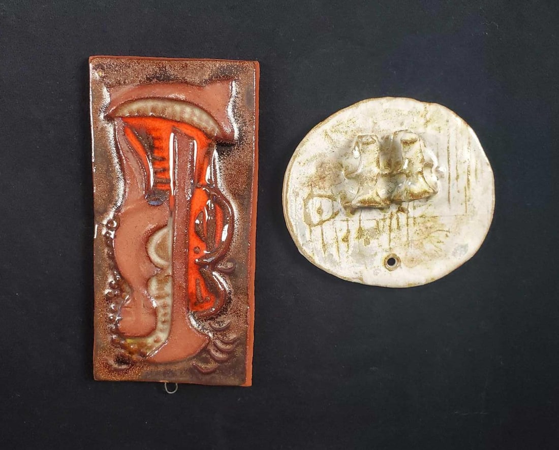 Earthenware Wall Art Lot Of Two: This lot includes hand-made earthenware art that is suitable to hang on your wall. This lot includes: (1) Earthenware tile art. Both glazed and unglazed earthenware image of a man on a boat