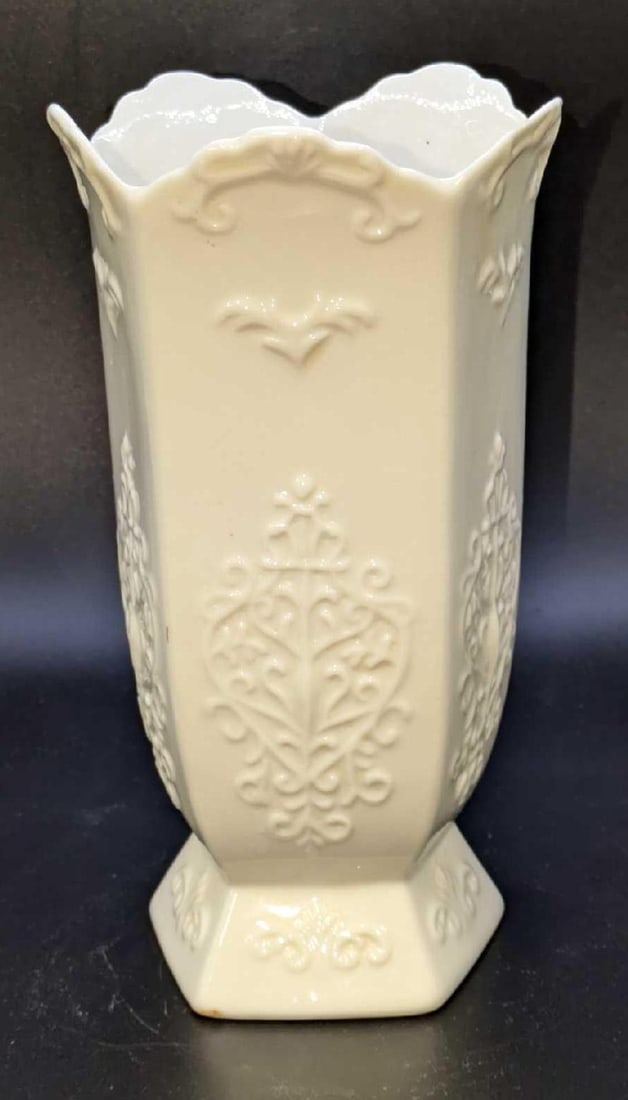 Vintage White Floral Ceramic Vase: Vintage White Floral Ceramic Vase. The maker and date of creation is unknown. The vase is approx 3" x 3" x 7 1/2" and it weighs 1.12lb. The vase has some markings on the bottom and a small scratch on 